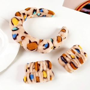 Detailed view of colorful leopard print plush headband and matching wristbands set