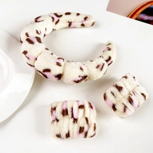 Macro detail of plush leopard print flannel headband and matching wristbands set