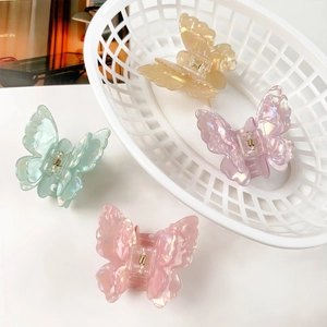 Iridescent butterfly hair claws in pastel mint, purple, pink, and amber colors