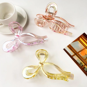 Detailed macro view of colorful translucent bow hair clips with iridescent coating finish