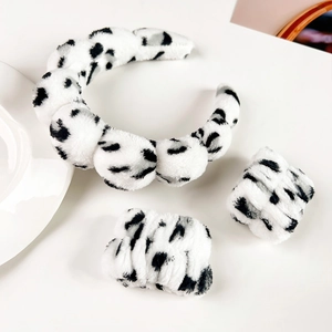 Three-piece flannel set including a thick cloud headband and two wristbands in cow print