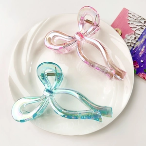 Elegant iridescent butterfly hair claws in pink and blue finish for high ponytail styling