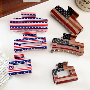 Detail view of American flag acrylic hair claws in multiple sizes and vintage textures