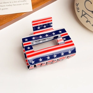 Detail of a glossy acrylic hair claw clip with American flag stars and stripes pattern