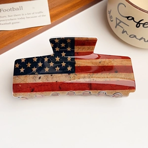 Close-up of high-gloss American flag pattern on a durable acrylic hair claw clip