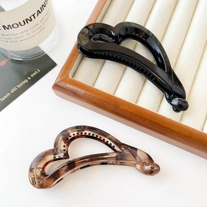 Elegant banana hair clips in black and amber tortoise shell finish for ponytails