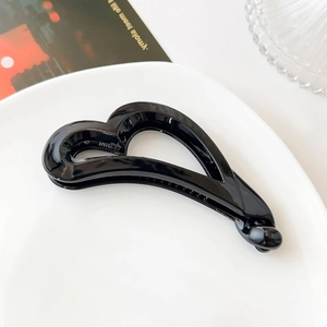 Macro shot of glossy black heart banana clip inner teeth and NWM-37 model mark