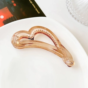 Detailed macro view of the heart-shaped banana hair clip with internal anti-slip teeth