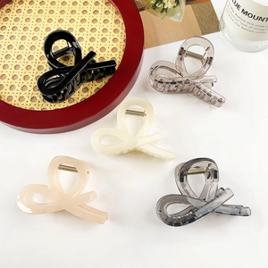 Set of five glossy resin hair claw clips in neutral shades like black and cream