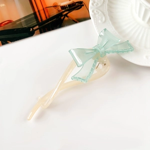 Dettaglio della clip per capelli a fiocco verde menta con resina crema e denti antiscivolo