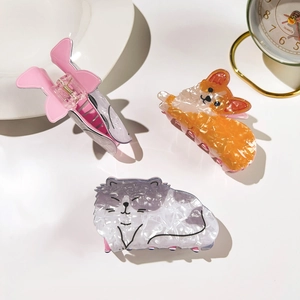 Detailed view of acetate animal hair claws including pink bunny, corgi dog and cat patterns