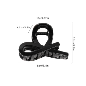 Glossy black hair claw clip with cross knot design and dimensions 8cm by 5.5cm