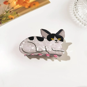 Detail of a black and white cat hair claw clip made from marble texture acetate material