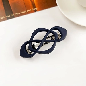 Detailed view of dark blue matte hair clip with geometric hollow design and metal spring