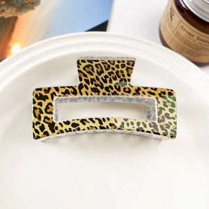 Close-up of leopard print square hair claw clip placed on a white decorative tray