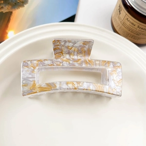 Macro view of square hollow hair claw clip with cream marble leopard pattern