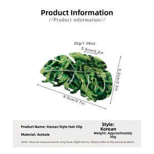Détail de la pince à cheveux en acétate en forme de feuille avec texture marbrée verte
