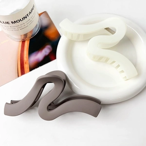 Minimalist matte wave claw clips in cream and mocha grey colors for thick hair