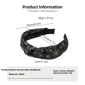 Detail view of a black spider web knot headband showing fabric texture and 16cm diameter