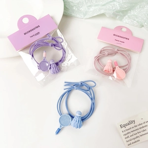 Detail of badminton racket and shuttlecock charms on elastic hair ties in pastel colors