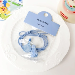 Detailed shot of cute blue badminton racket and shuttlecock charms on elastic hair ties