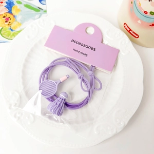 Detailed close-up of purple badminton racket and birdie charms on elastic hair ties