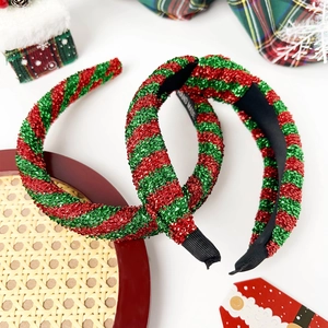 Detailed view of handmade Christmas headbands with red and green metallic spiral stripes
