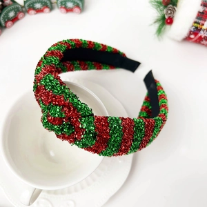 Detail view of a knotted Christmas headband with red and green sequins in festive setting