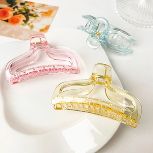 Detailed trio of amber, pink and blue fishtail hair claws in a refined setting