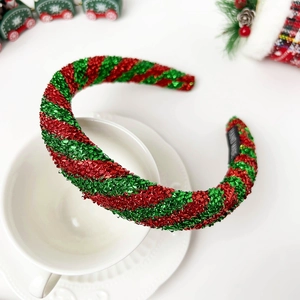 Detailed macro of festive red and green striped handmade headband with shimmering texture