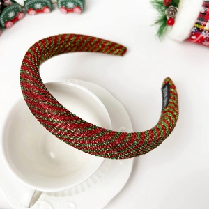 Close-up of sparkling red and green sequin headband with handmade tag on a white cup