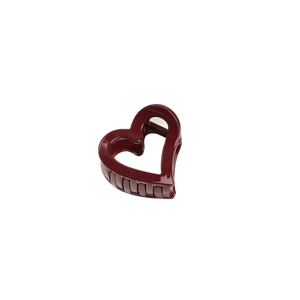 Minimalist deep red heart-shaped hair claw clip with glossy finish on white background
