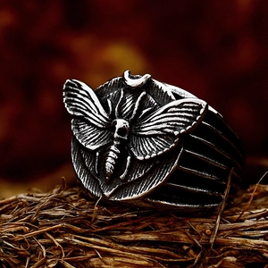 Vintage gothic men's stainless steel skull moth ring with crescent moon on dried straw