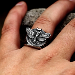 Macro detail of a vintage Gothic death's-head hawkmoth ring in stainless steel for men