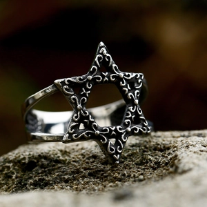 Vintage stainless steel ring with engraved hexagram star and floral patterns on natural stone