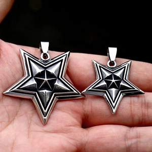 Detailed close-up showing vintage stainless steel star pendants in two different sizes