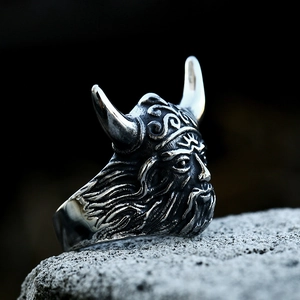 Macro shot of a Viking warrior ring with detailed helmet carvings on grey stone