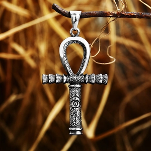 Close-up of vintage stainless steel Ankh cross pendant with Eye of Horus motif