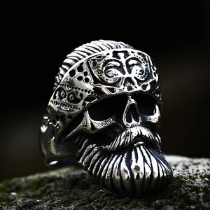 Macro shot of punk biker skull ring with engraved bandana and long textured beard