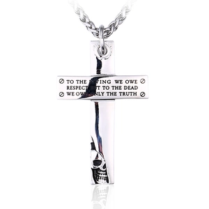 Gothic stainless steel cross necklace with skull relief and engraved quote on white background
