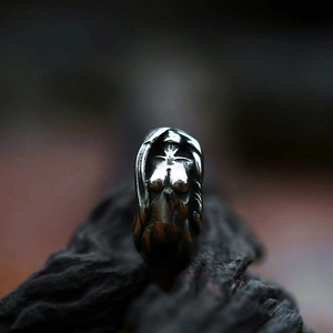 Macro detail of vintage stainless steel ring with artistic body sculpture relief carving