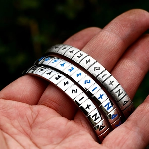 Close-up of vintage Viking rune engravings on stainless steel bracelets for men