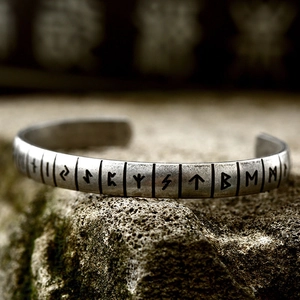 Vintage stainless steel Viking Rune cuff bracelet for men on a mossy rock