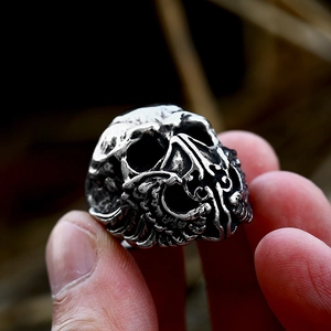 Macro shot of a vintage punk skull ring with mask textures in antique silver finish