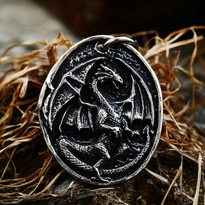 Vintage stainless steel oval pendant featuring detailed relief of a western flying dragon