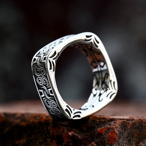 Vintage stainless steel square ring with black Celtic patterns on red mineral stone