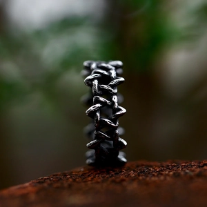 Vintage oxidized stainless steel woven chain ring with a retro silver finish in nature