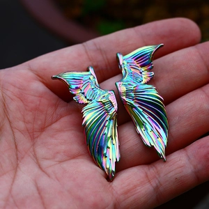 Macro detail of iridescent angel wing pendants with colorful electroplated finish