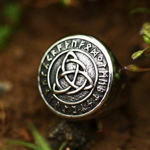 Macro shot of Viking stainless steel ring featuring Triquetra knot and Runic engraving