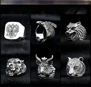 Detailed collection of vintage stainless steel rings featuring eagle, wolf, and tiger motifs